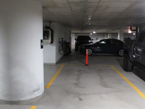 a view of parking garage with cars parked