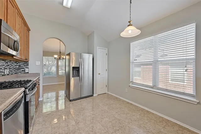 a view of a kitchen with an empty space and a window