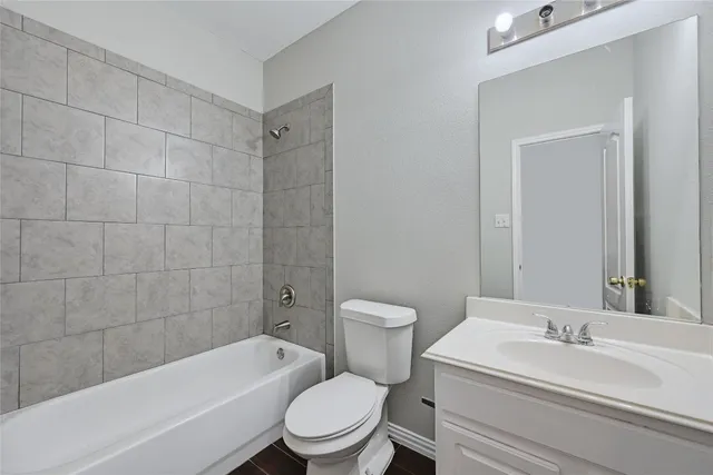 a bathroom with a toilet a sink and bathtub