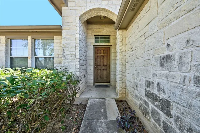 a view of entrance of a house with a garden