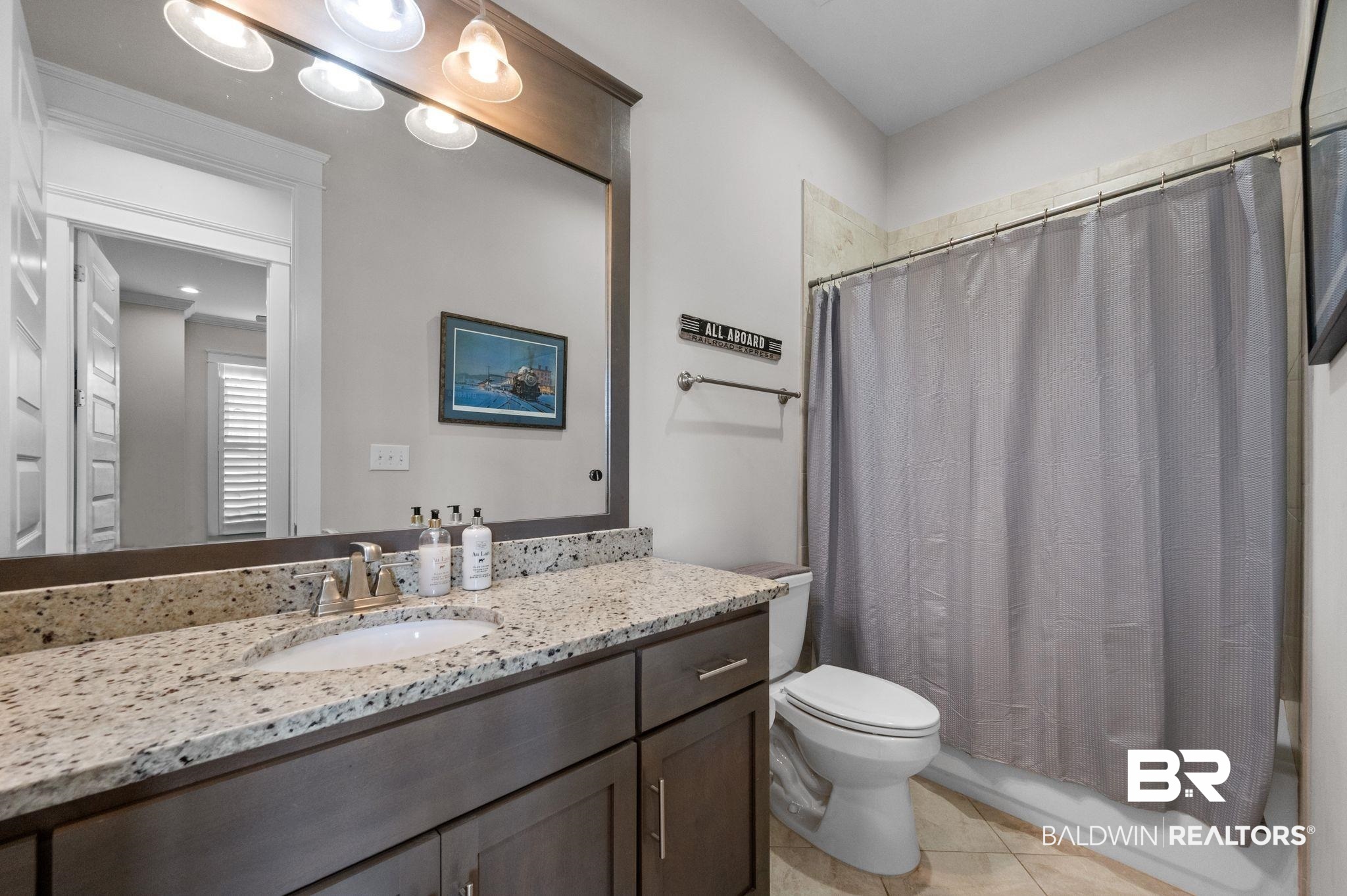 32194 Badger Court Daphne, AL 36527 - Photo 35 of 49 Full bath featuring vanity, light tile patterned flooring, and shower / bath combination with curtain