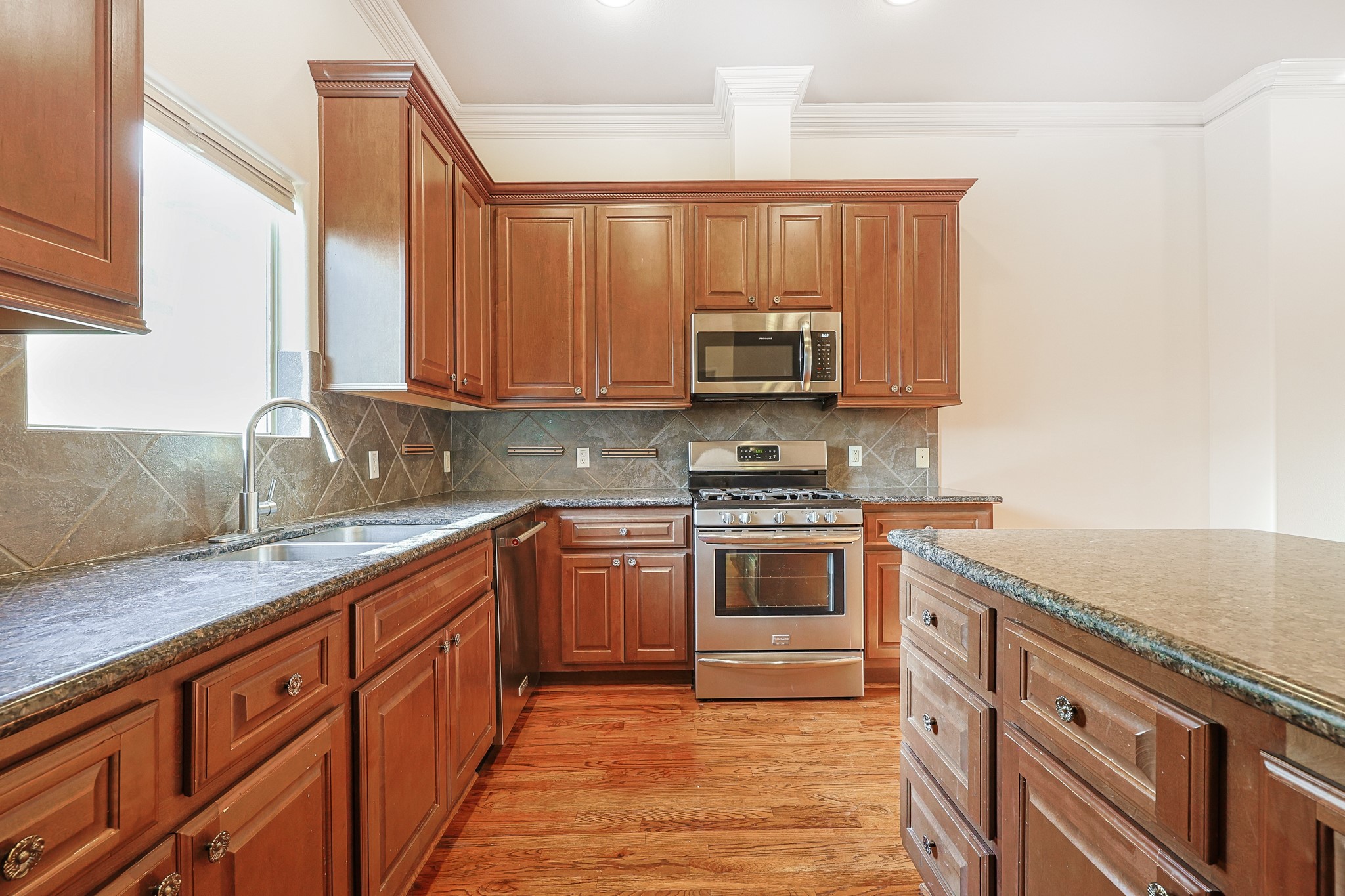 2540 Prospect Street, Unit C Houston, TX 77004 - Photo 11 of 31 a kitchen with stainless steel appliances granite countertop a stove a sink and a microwave