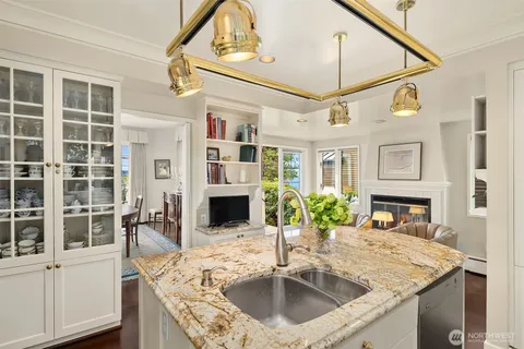 a kitchen with stainless steel appliances granite countertop a sink and a refrigerator
