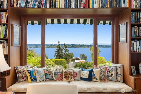 a living room with furniture fireplace and a large window
