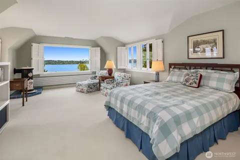 a spacious bedroom with two beds and painting on the wall
