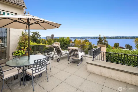 a view of deck with furniture and umbrella