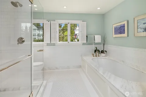 a white bath tub sitting next to a white sink