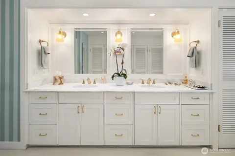 a bathroom with a double vanity sink mirror and