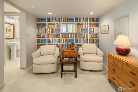 a living room with furniture and a book shelf