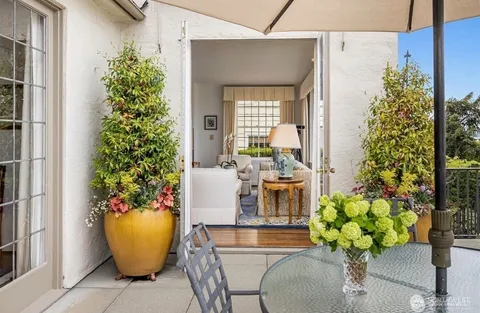 a dining room with furniture and a potted plant