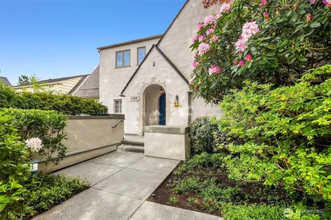 a front view of a house with a garden