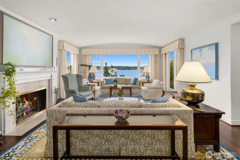 a living room with furniture a fireplace and a table