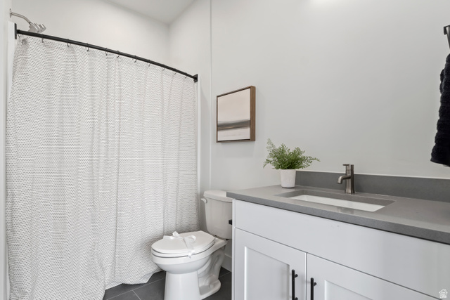 32 West 400 South Bountiful, UT 84010 - Photo 27 of 31 Bathroom featuring vanity, curtained shower, and dark tile patterned floors