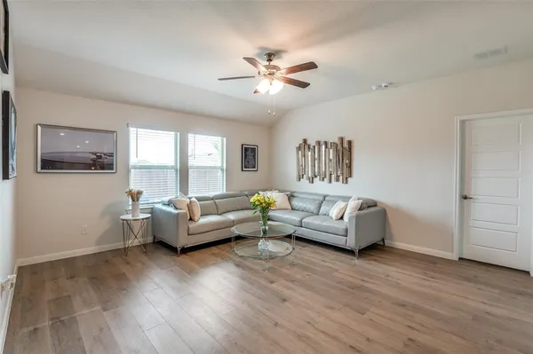 a living room with furniture and a large window