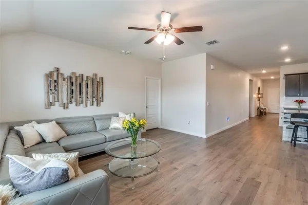 a living room with furniture and wooden floor
