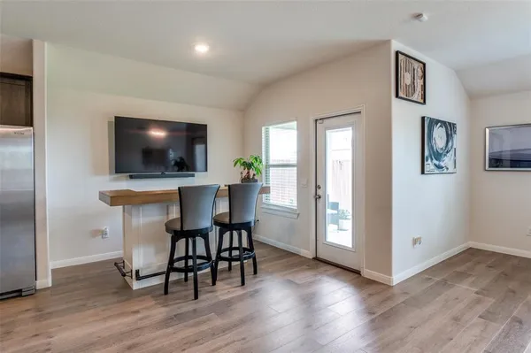 a view of a livingroom with furniture and a flat screen tv