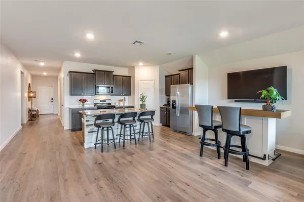 a view of a dining room with furniture and wooden floor