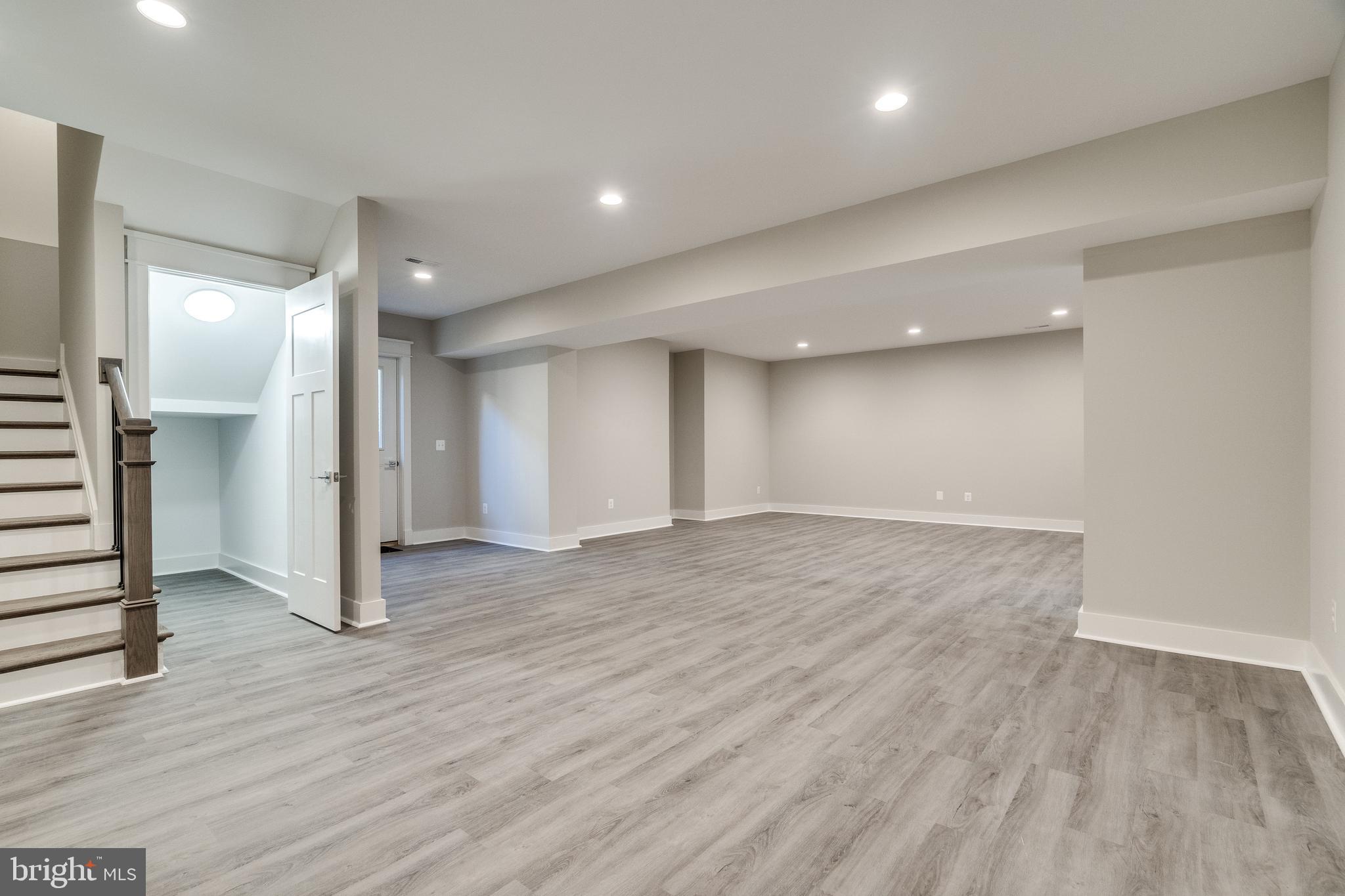 8016 Wellington Road Alexandria, VA 22308 - Photo 31 of 43 Walk-out basement w/ water resistant vinyl plank