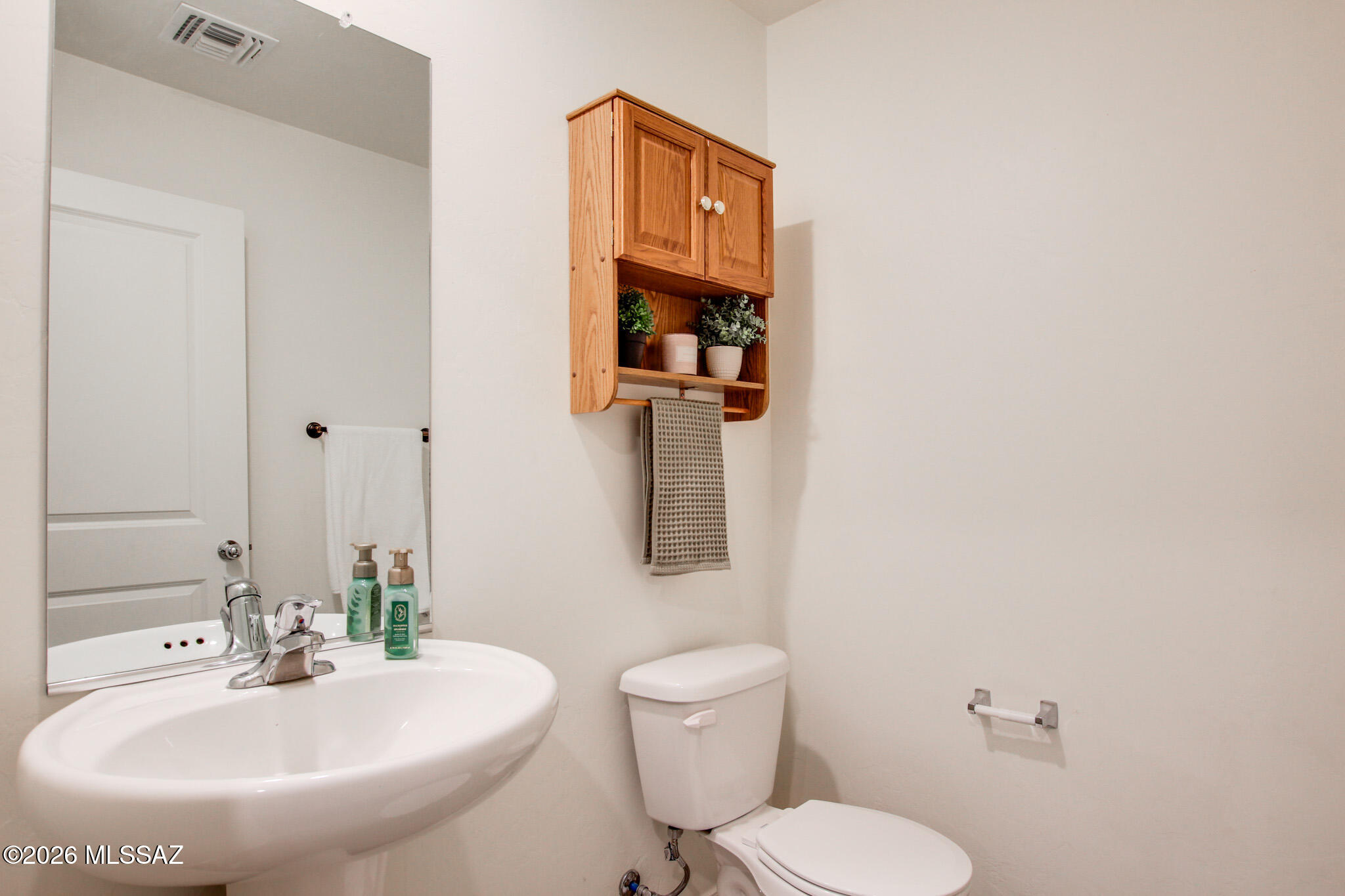 5987 South Antrim Loop Tucson, AZ 85706 - Photo 17 of 34 a bathroom with a toilet sink and mirror