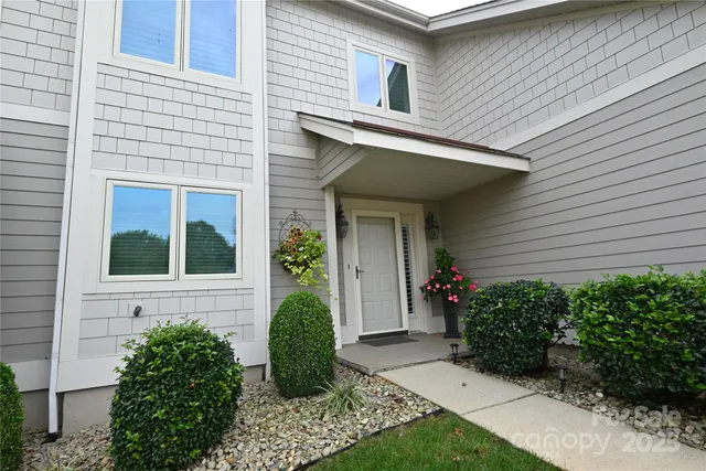 a view of a house with potted plants
