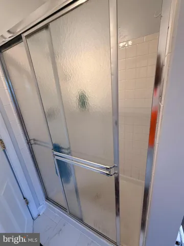 a bathroom with a glass shower door