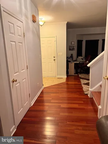 a view of a livingroom with wooden floor and staircase