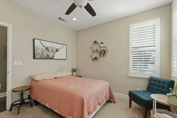 a bedroom with a bed and chair