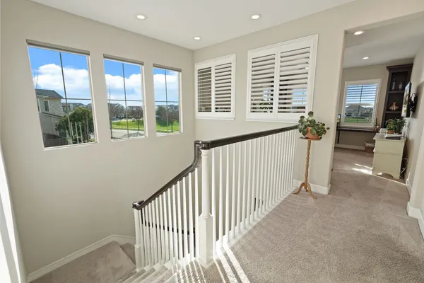 a view of staircase with white walls and windows