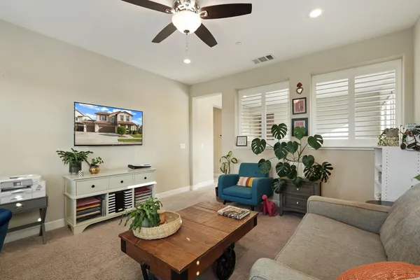 a living room with furniture potted plant and a window
