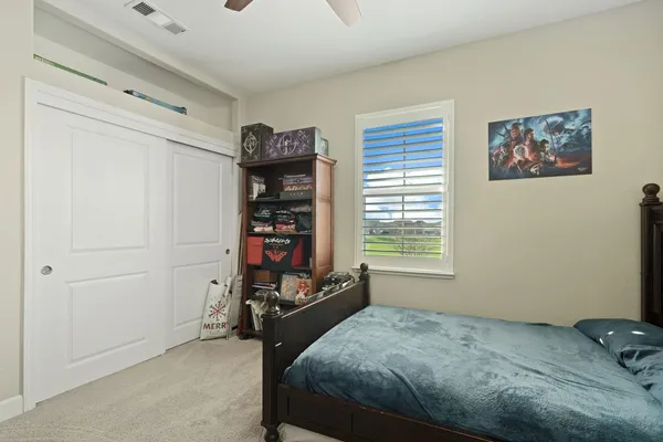 a bed room with a bed and a window