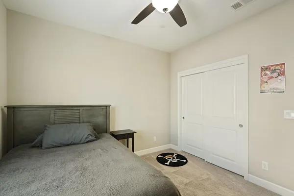 a bedroom with a bed and a natural light