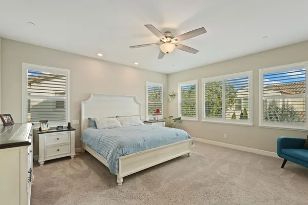 a spacious bedroom with a bed and window