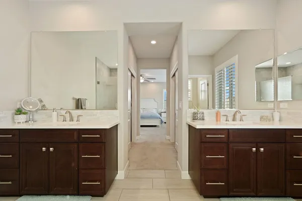 a spacious bathroom with a granite countertop sink and mirror