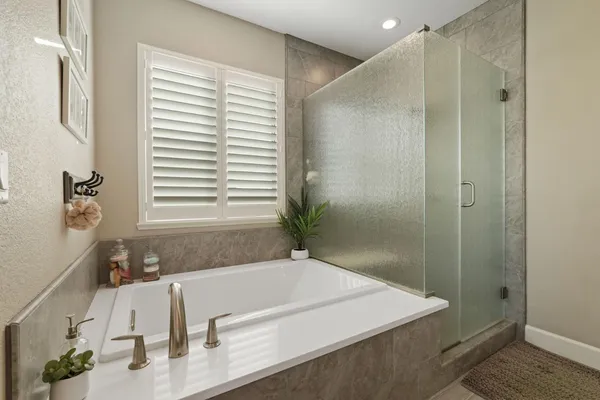 a bathroom with a tub and a sink