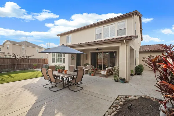 a view of a house with patio and a garden