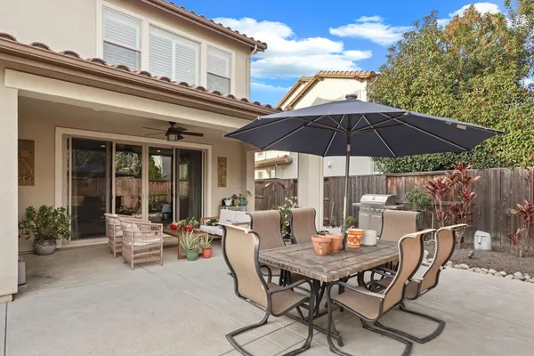 a view of a patio with furniture and a umbrella