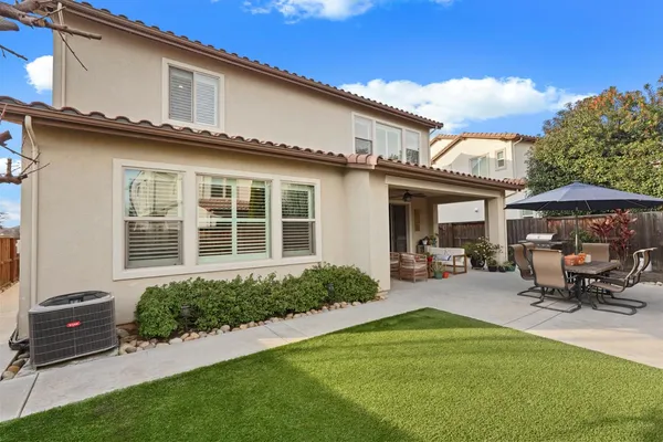 a front view of a house with sitting area and garden