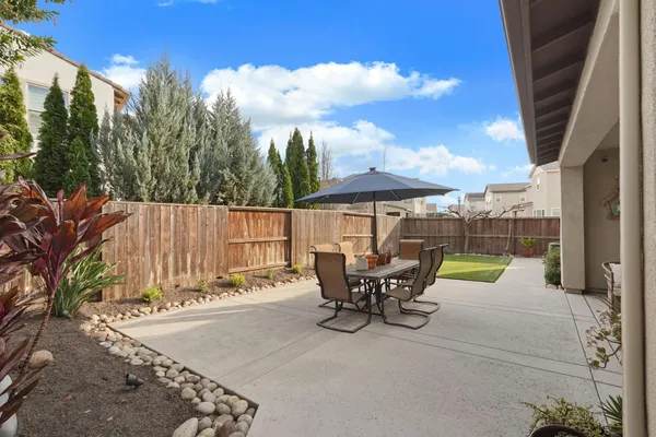 a view of outdoor sitting area with furniture and wooden fence