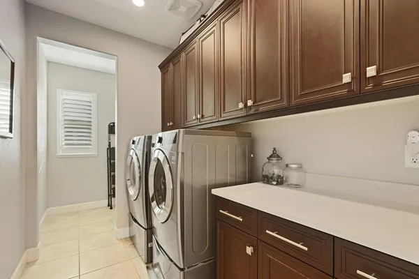 a utility room with multiple dryer and washer