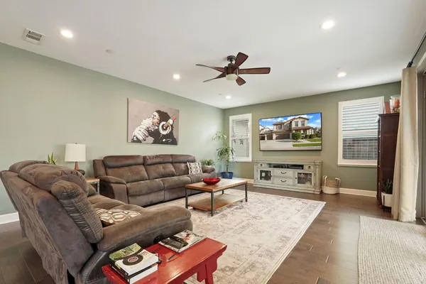 a living room with furniture a rug and a flat screen tv