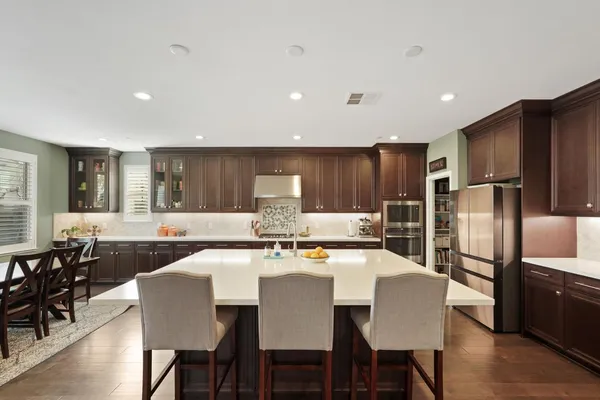 a large kitchen with a table and chairs