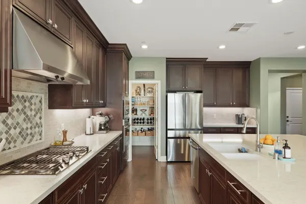 a kitchen with kitchen island a sink stove and refrigerator