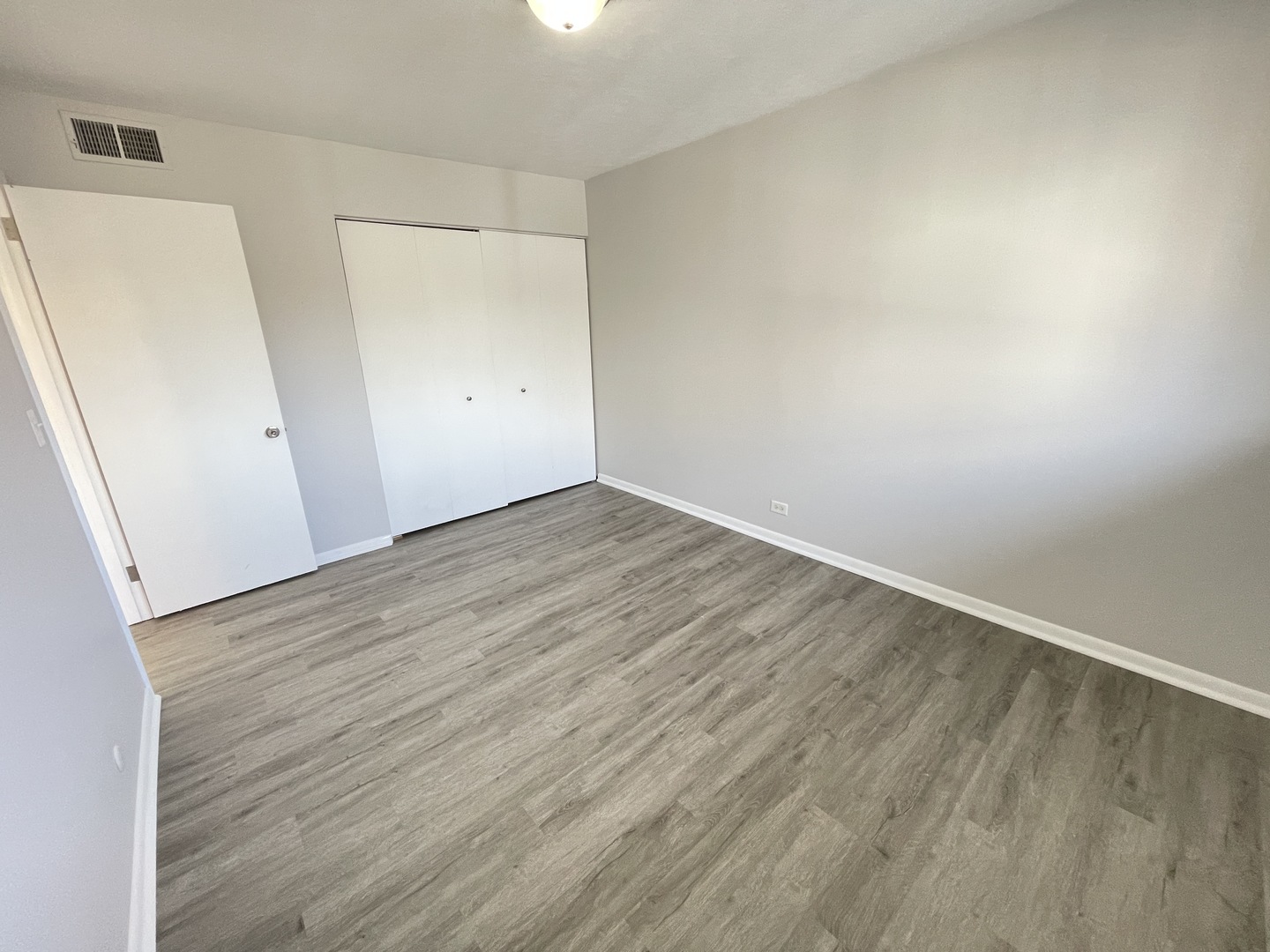 235 East Palatine Road, Unit 2B Palatine, IL 60067 - Photo 5 of 12 an empty room with wooden floor