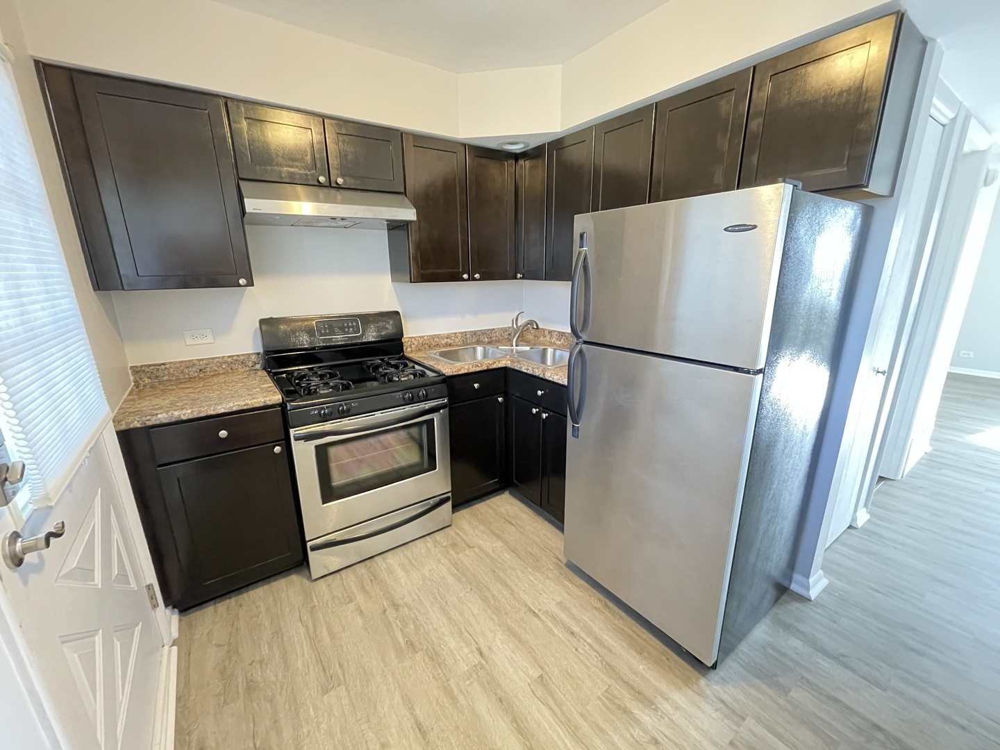 235 East Palatine Road, Unit 2B Palatine, IL 60067 - Photo 6 of 12 a kitchen with a refrigerator sink and wooden floor