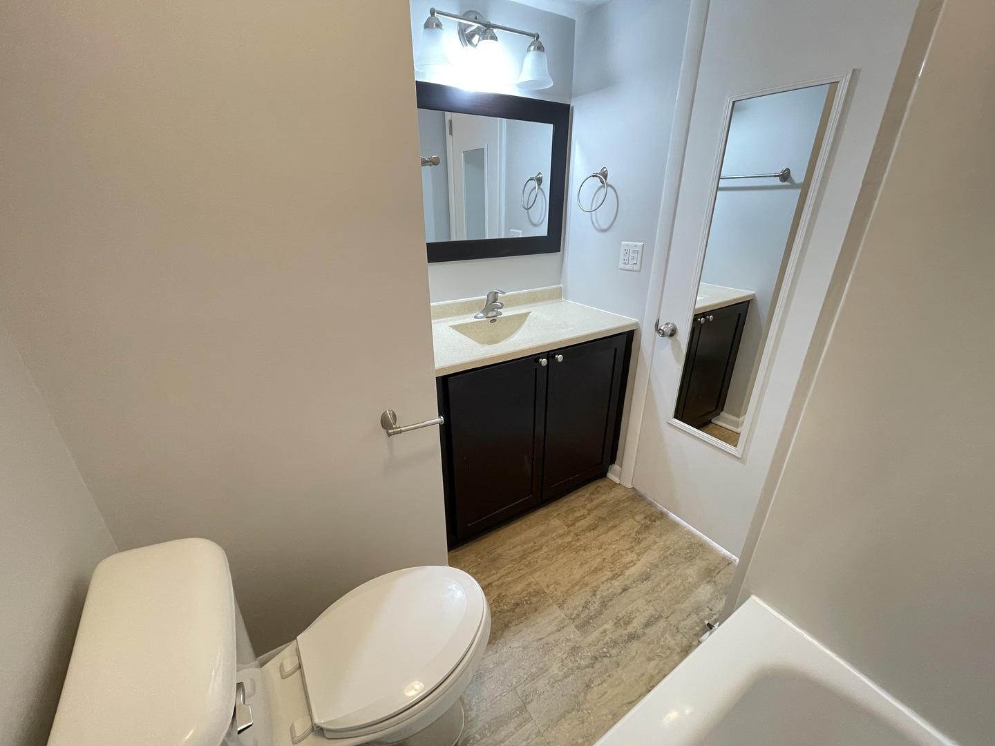 235 East Palatine Road, Unit 2B Palatine, IL 60067 - Photo 8 of 12 a bathroom with a sink vanity granite toilet and a mirror