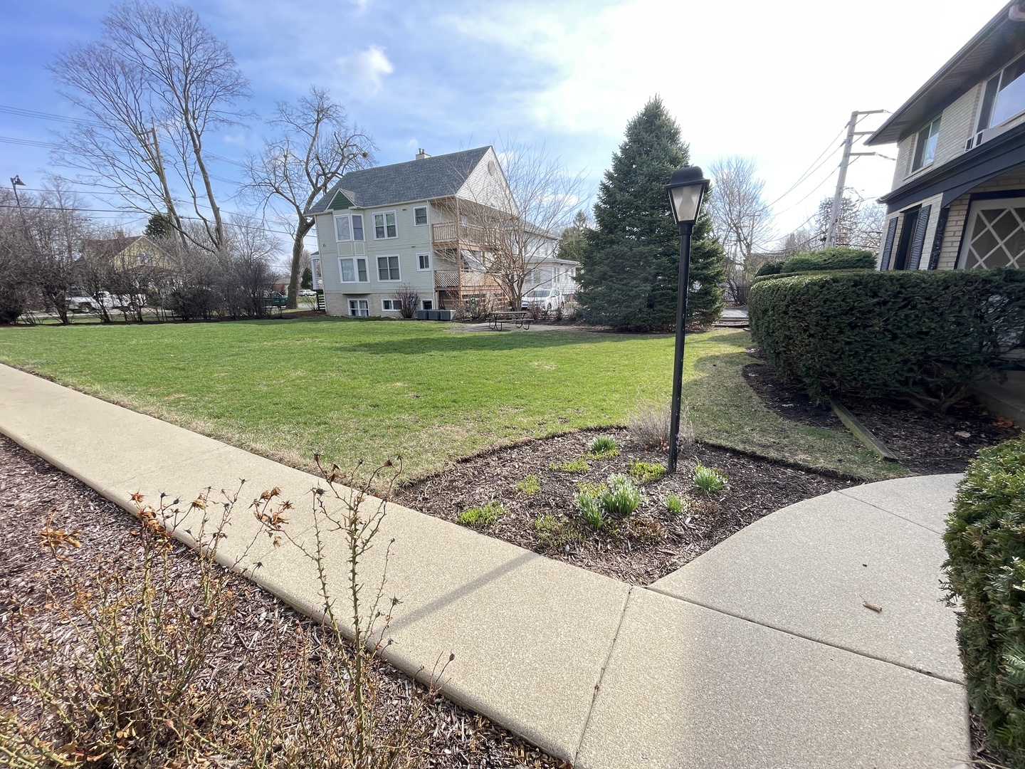 235 East Palatine Road, Unit 2B Palatine, IL 60067 - Photo 9 of 12 a view of a garden with house in the background