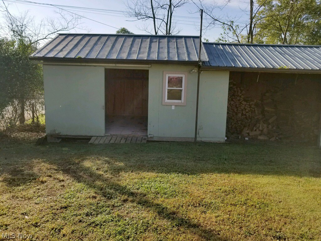 29 Fall Run Road Walker, WV 26180 - Photo 9 of 35 Work shop 16x11 with full electric ...sliding door...and just to the right of the shed is fully stocked firewood for the wood burning fireplace located in the great room...the fireplace is capable of heating the entire home!