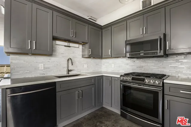 a kitchen with a sink and cabinets