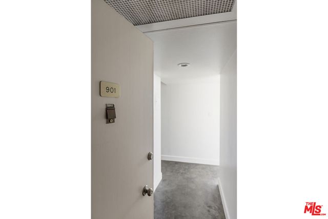 a view of a room with a white wall