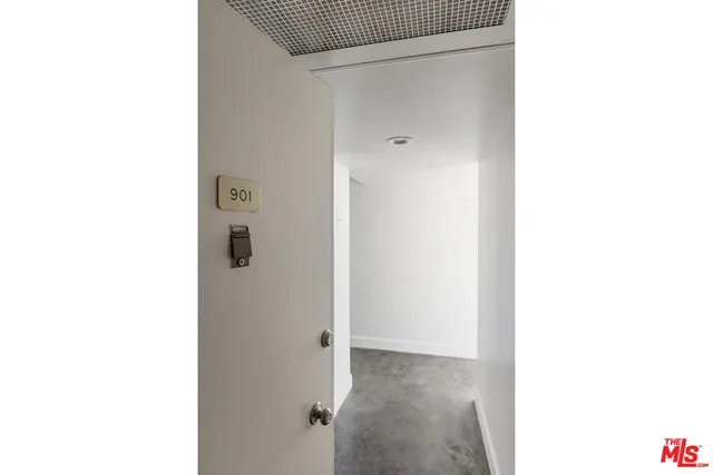 a view of a room with a white wall